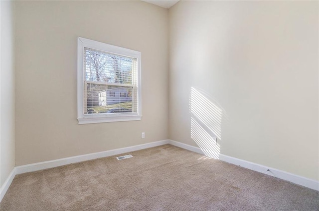 spare room with light colored carpet