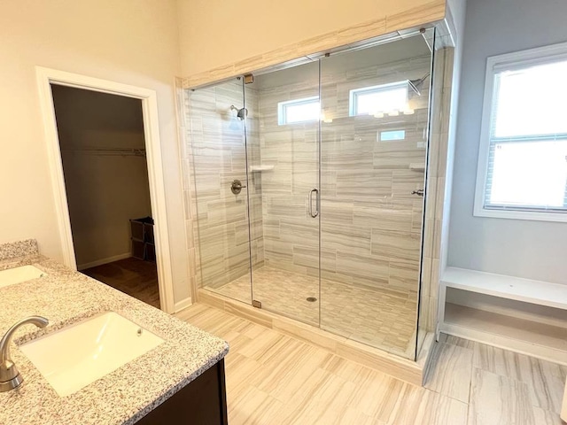 2300 Ivy Birch Ln, Buford, GA 30519 - bathroom featuring a stall shower, double vanity, and a walk in closet