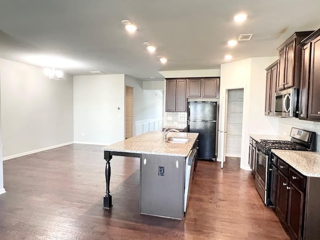 2300 Ivy Birch Ln, Buford, GA 30519 - kitchen with appliances with stainless steel finishes, tasteful backsplash, an island with sink, a breakfast bar, and recessed lighting