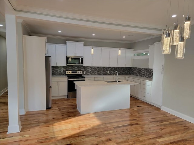 kitchen featuring sink, white cabinets, appliances with stainless steel finishes, and light wood-type flooring