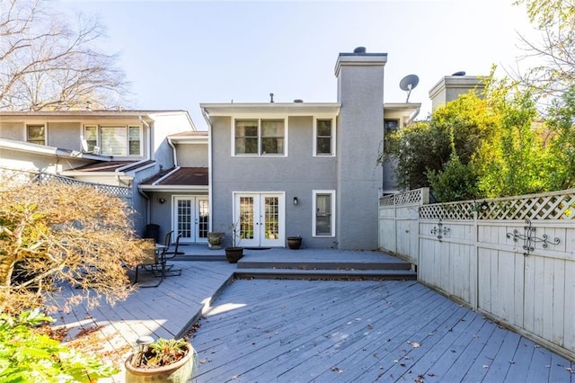 back of property featuring a wooden deck and french doors