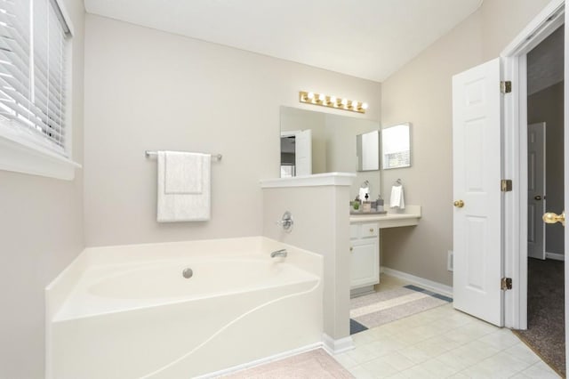 bathroom with a bath, baseboards, and vanity