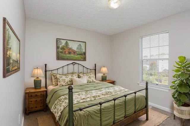 bedroom with carpet floors and baseboards