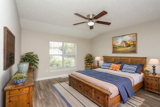 bedroom with light wood-style flooring, baseboards, and a ceiling fan