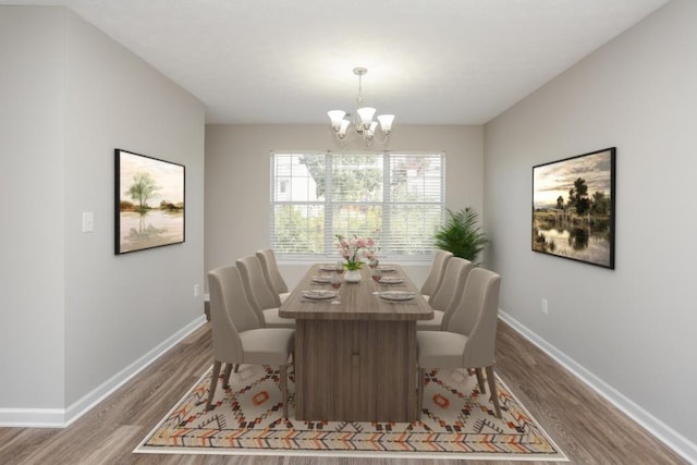 dining room with wood finished floors, a chandelier, and baseboards