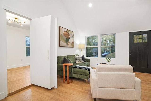 living room featuring hardwood / wood-style flooring and vaulted ceiling