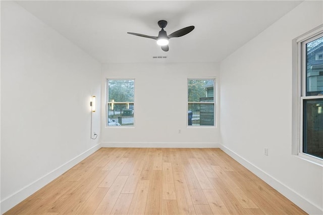 empty room featuring ceiling fan and light wood-type flooring