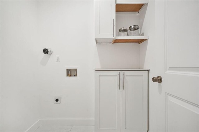 laundry room featuring electric dryer hookup, hookup for a washing machine, and light tile patterned flooring