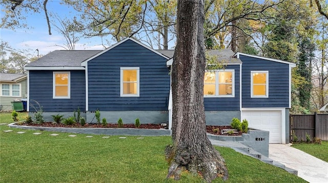 view of front of home with a garage and a front lawn