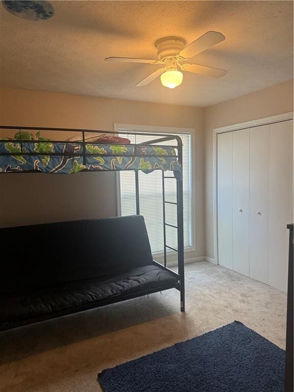 3120 Seven Pines Ct Unit 203, Atlanta, GA 30339 - carpeted bedroom with ceiling fan, a textured ceiling, and a closet