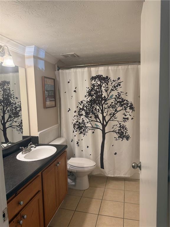 3120 Seven Pines Ct Unit 203, Atlanta, GA 30339 - bathroom featuring tile patterned flooring, vanity, a textured ceiling, and curtained shower