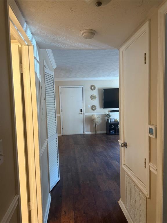 3120 Seven Pines Ct Unit 203, Atlanta, GA 30339 - hall featuring a textured ceiling and dark wood-type flooring