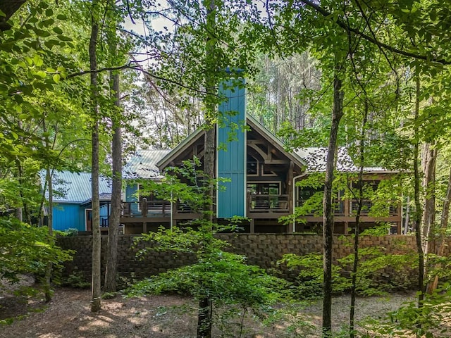 back of house featuring a wooden deck