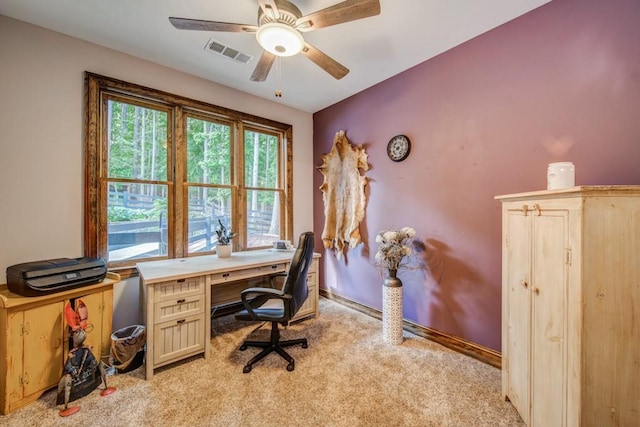 carpeted office featuring ceiling fan