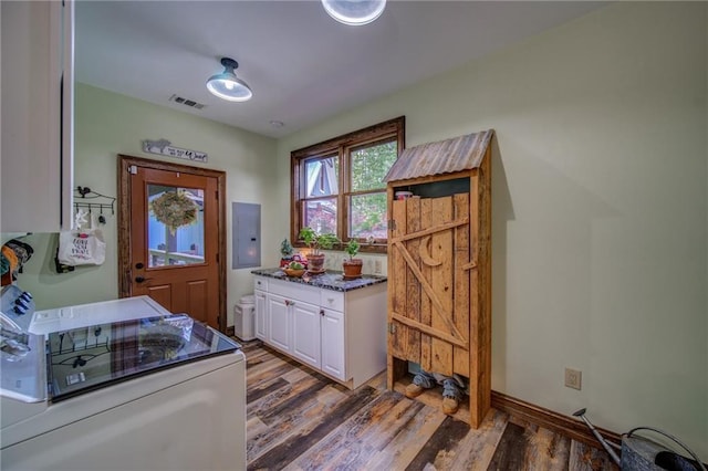 interior space featuring electric panel, dark wood-type flooring, white cabinets, and white electric range oven