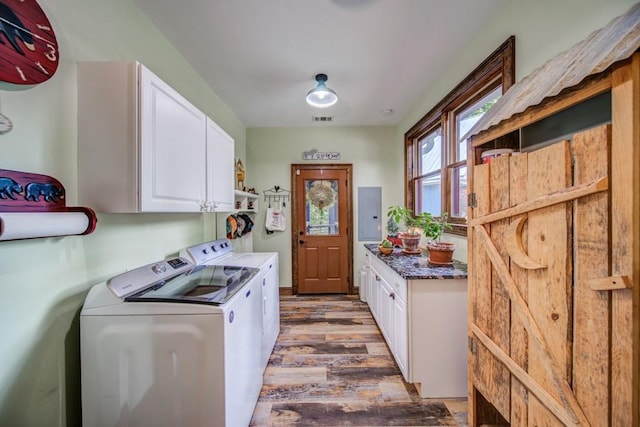 laundry room with washer and clothes dryer, dark hardwood / wood-style flooring, cabinets, and electric panel