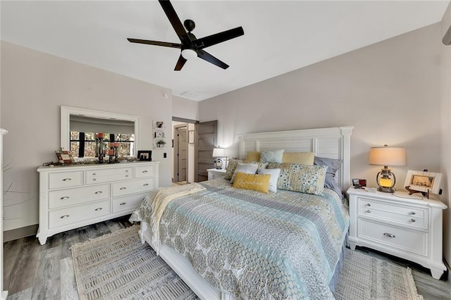 bedroom with ceiling fan and dark wood-type flooring