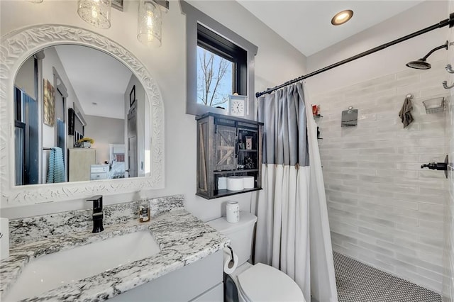 bathroom with tile patterned floors, vanity, toilet, and curtained shower