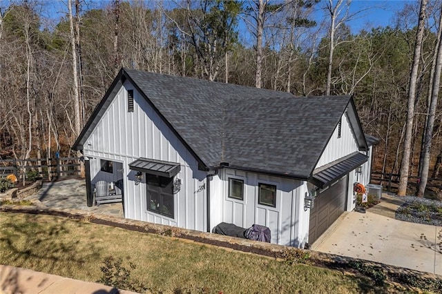 exterior space with a yard, cooling unit, and a garage