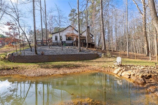 back of property featuring a water view