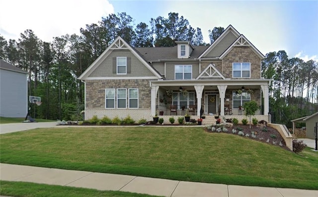 craftsman inspired home with a front yard and a porch