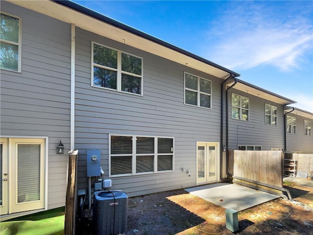 back of house with french doors and central AC unit