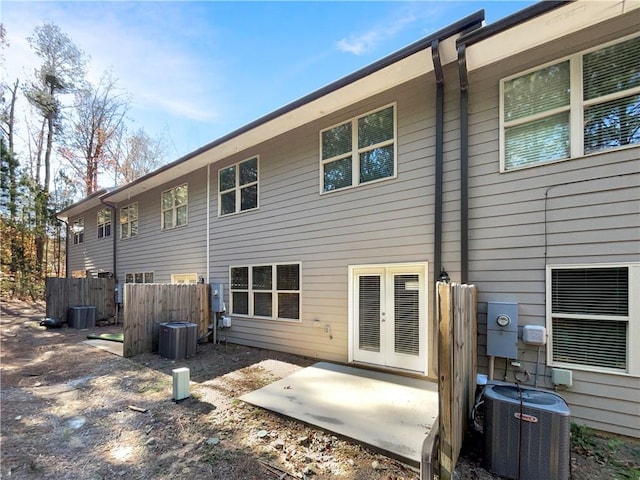 rear view of property featuring french doors and central air condition unit