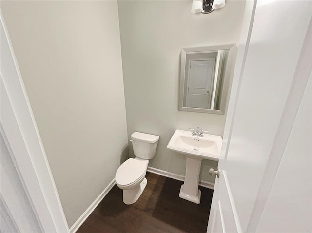 bathroom featuring sink, hardwood / wood-style floors, and toilet