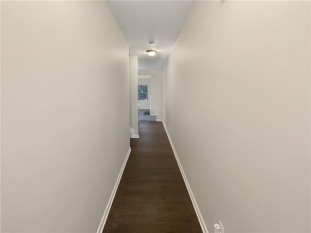 hallway with dark hardwood / wood-style floors