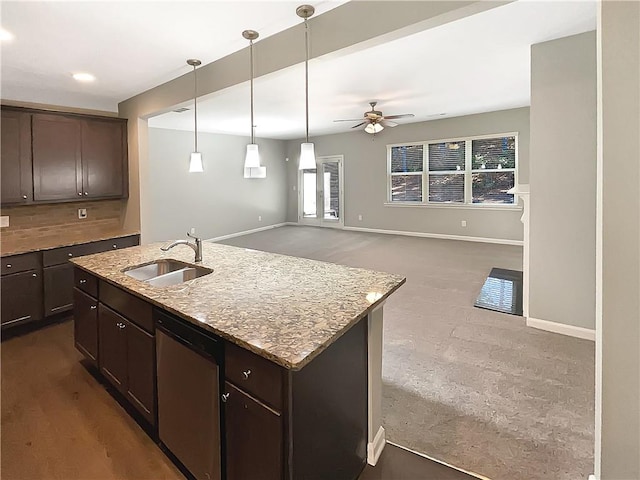 kitchen with dark brown cabinetry, ceiling fan, dishwasher, sink, and a center island with sink