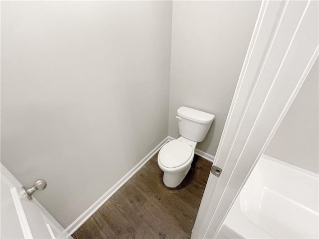 bathroom with toilet and hardwood / wood-style flooring