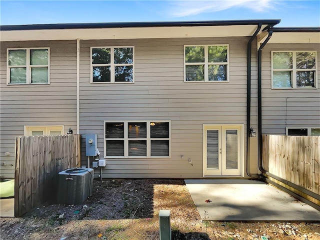 rear view of house featuring central AC unit and a patio area