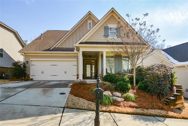 craftsman-style house with central AC and a garage