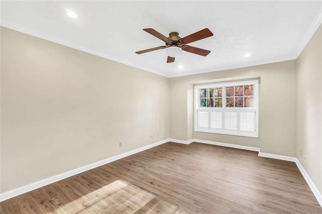 empty room featuring baseboards, ceiling fan, wood finished floors, crown molding, and recessed lighting