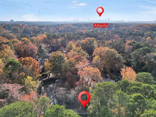 aerial view of property and surrounding area with a forest