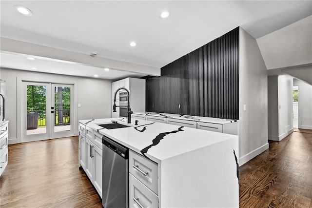 1887 Shalimar Dr, Atlanta, GA 30345 - kitchen with stainless steel dishwasher, a kitchen island with sink, white cabinetry, dark wood finished floors, and recessed lighting