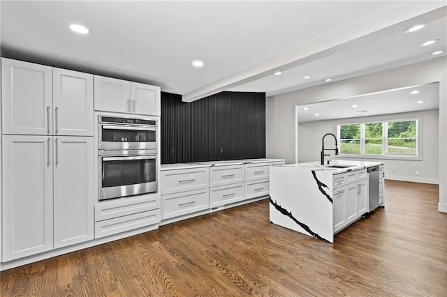 1887 Shalimar Dr, Atlanta, GA 30345 - kitchen featuring a sink, appliances with stainless steel finishes, white cabinets, dark wood-style floors, and recessed lighting