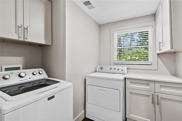 1887 Shalimar Dr, Atlanta, GA 30345 - laundry room with washing machine and clothes dryer, cabinet space, and baseboards