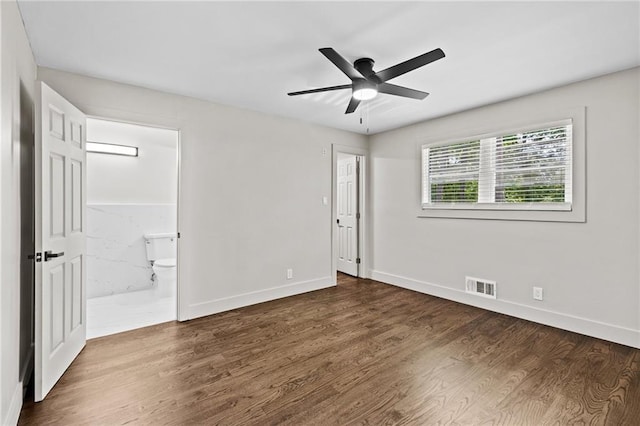 1887 Shalimar Dr, Atlanta, GA 30345 - unfurnished bedroom with wood finished floors, baseboards, connected bathroom, and a ceiling fan