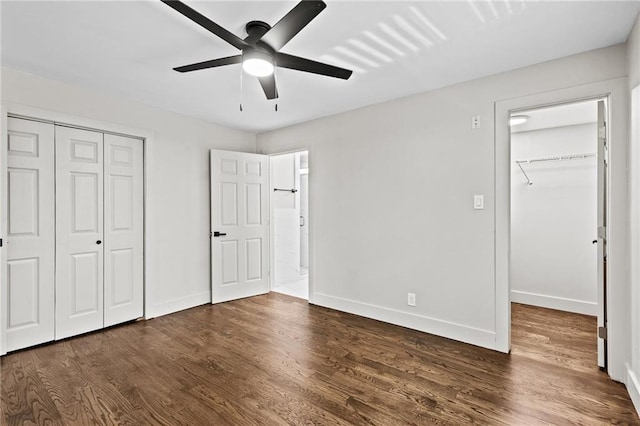 1887 Shalimar Dr, Atlanta, GA 30345 - unfurnished bedroom featuring a closet, wood finished floors, baseboards, and a walk in closet