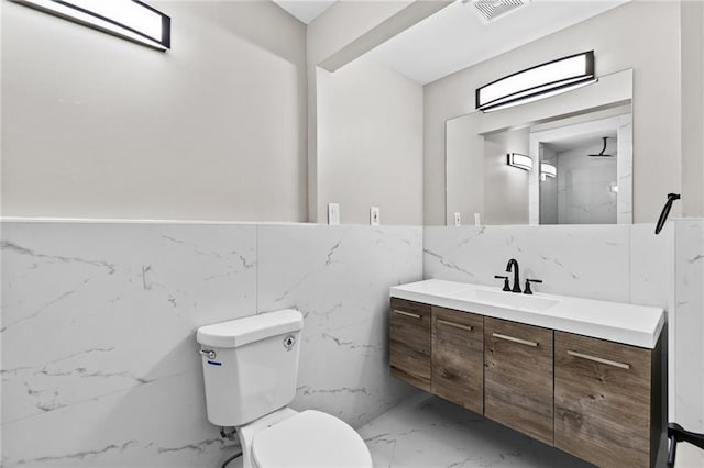 1887 Shalimar Dr, Atlanta, GA 30345 - bathroom featuring marble finish floors, vanity, toilet, tile walls, and a marble finish shower