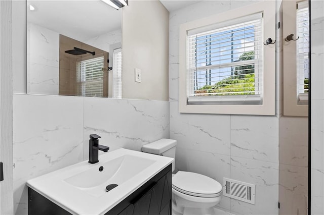 1887 Shalimar Dr, Atlanta, GA 30345 - bathroom featuring tile walls, vanity, toilet, and a shower