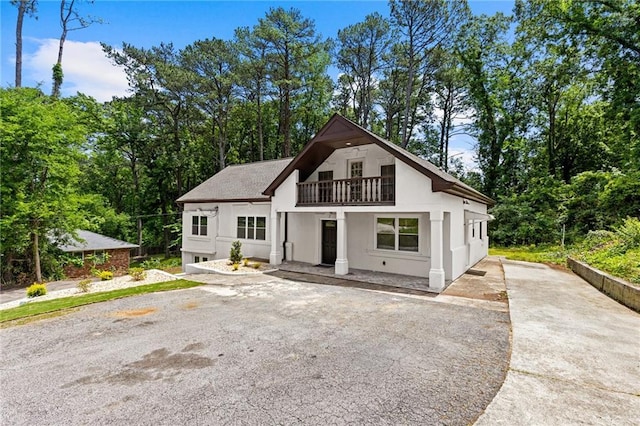 1887 Shalimar Dr, Atlanta, GA 30345 - modern farmhouse style home with a balcony, driveway, and stucco siding