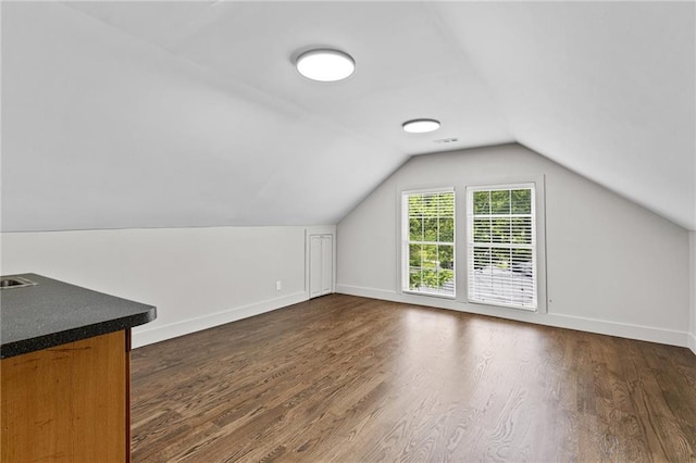 1887 Shalimar Dr, Atlanta, GA 30345 - bonus room featuring dark wood-style flooring, vaulted ceiling, and baseboards