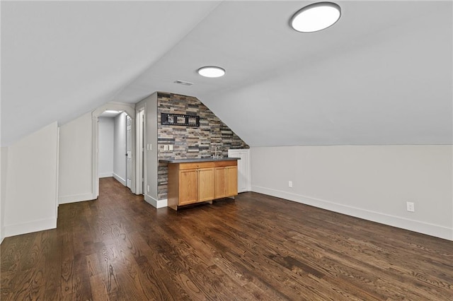1887 Shalimar Dr, Atlanta, GA 30345 - additional living space with baseboards, lofted ceiling, and dark wood-type flooring