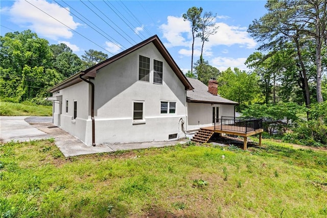 1887 Shalimar Dr, Atlanta, GA 30345 - back of property with a wooden deck, stucco siding, a yard, and a chimney