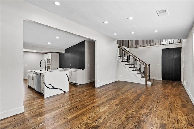 1887 Shalimar Dr, Atlanta, GA 30345 - kitchen with dishwasher, recessed lighting, dark wood finished floors, an island with sink, and light countertops