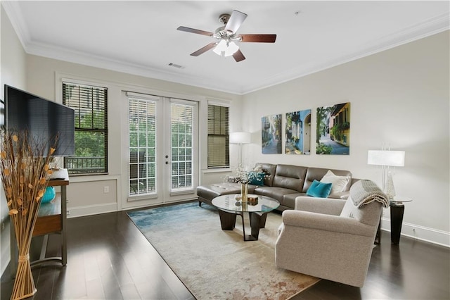 living room with french doors, crown molding, ceiling fan, and dark wood-type flooring