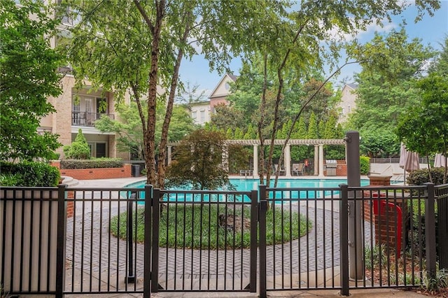 exterior space featuring a community pool and fence