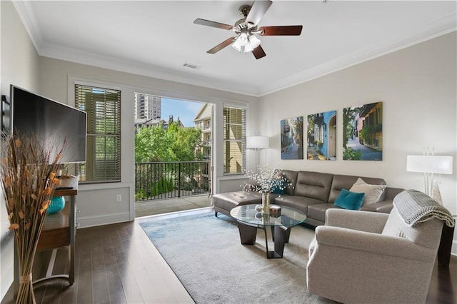 living room featuring dark hardwood / wood-style floors, ceiling fan, and crown molding